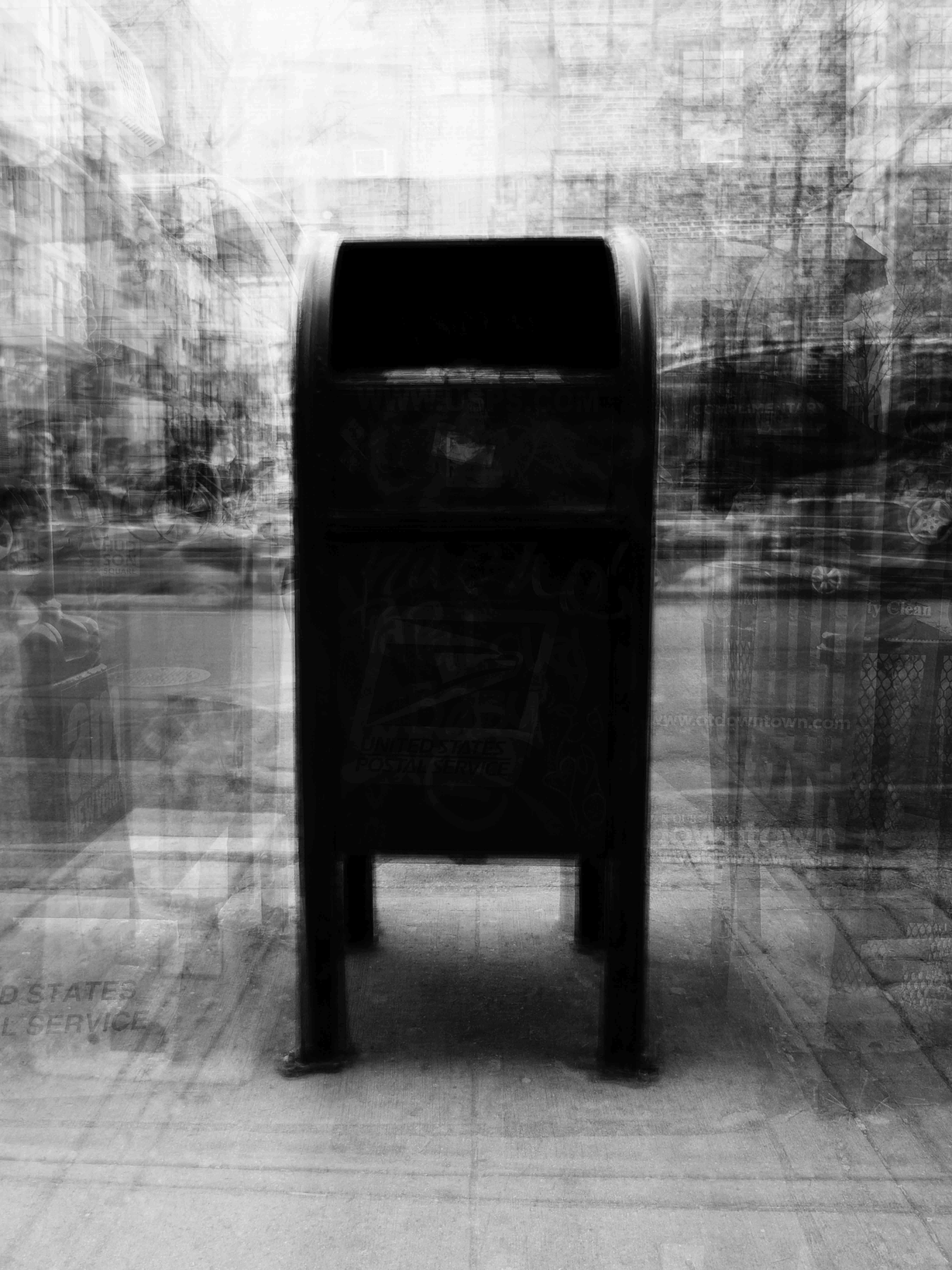 A black and white photo captures a New York City postal service box.