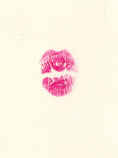 An imprint of pink pursed lips on off-white ground.