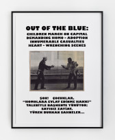 A framed image with black text, white background, and a black & white photo in the center hangs on a wall. The photo depicts a cop on the left who reaches towards a man holding a gun and a young child on the right. Above the photo it says, 