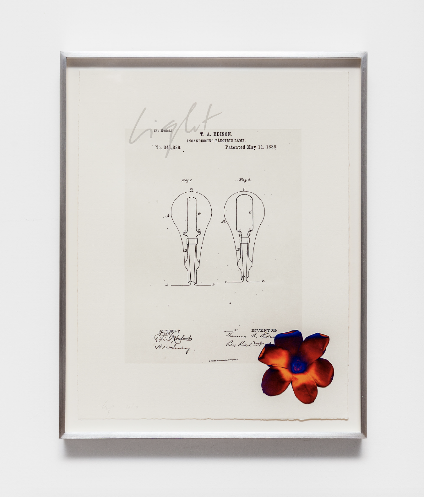 A white framed image hangs on a wall. The image shows line-drawn diagrams of lightbulbs. Above the diagrams it reads, 