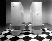 A black and white photo of two monolithic sculptures side by side.