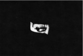 A black and white photo of an eye cropped with a heavy black border.